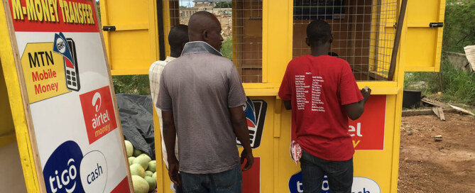 Men buy mobile phone cards in Ghana