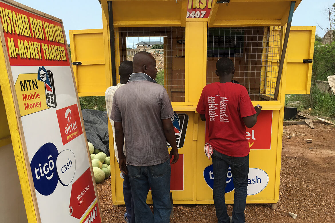 Men buy mobile phone cards in Ghana