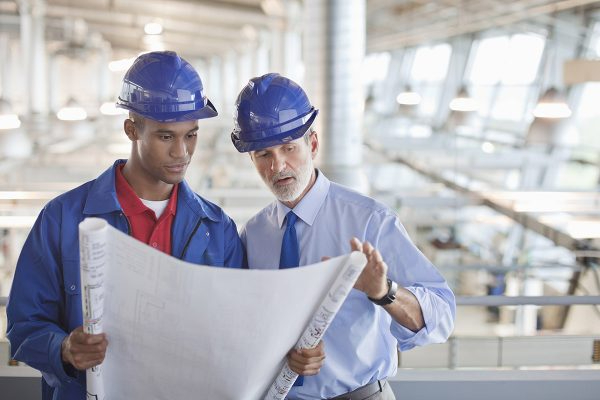 Contractor and architect review blueprints