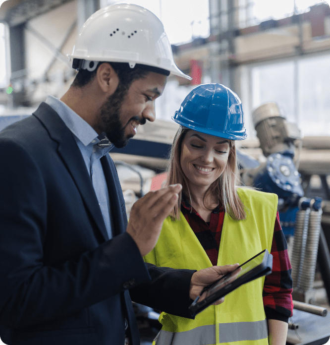 Manager works with employee to review project specs on-site