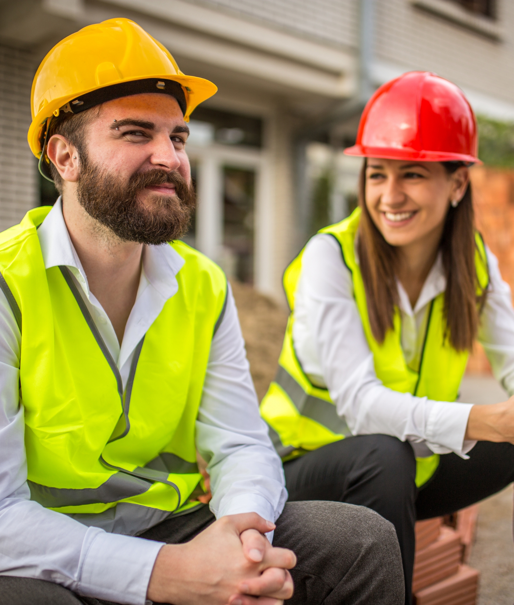 male and female construction worker, smiling